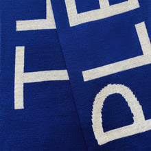 Load image into Gallery viewer, Blue wool with white text close up