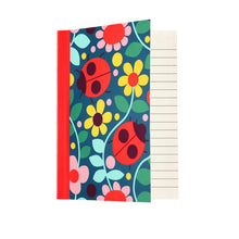 Load image into Gallery viewer, A6 notebook with colourful ladybird and flower illustration on the cover.