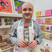 Load image into Gallery viewer, Arthouse Unlimited Be Happy incense sticks displayed with artist, showcasing ethical home fragrance and art-inspired wellbeing gift.