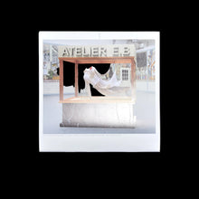 Load image into Gallery viewer, Display of a dress with 'Atelier E.B.' branding in a decorative setting.