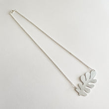 Load image into Gallery viewer, A silver-plated trace chain necklace with a bold silver leaf-shaped pendant, presented on a white background.