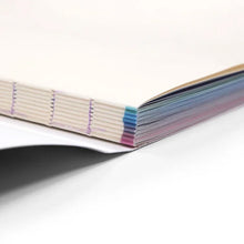 Load image into Gallery viewer, Close-up of Design and Disability exhibition catalogue spine and page edges showing paperback format.