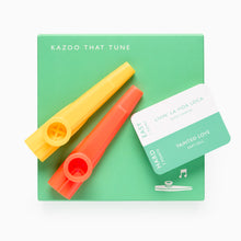 Load image into Gallery viewer, Two colorful kazoos on a green box with music notes.