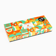 Load image into Gallery viewer, Colorful box with geometric patterns and text on a white background