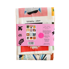 Load image into Gallery viewer, Back of the Arty Cats tea towel packaging with colourful design and text on a white background