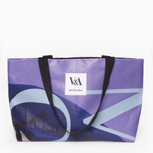 Load image into Gallery viewer, Upcycled landscape tote bag made from recycled Kimono exhibition banner in purple and blue with white V&A Dundee logo patch on the front.