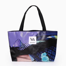 Load image into Gallery viewer, Landscape tote bag crafted from recycled exhibition banner showing unique purple and blue graphic design with V&A Dundee logo patch.