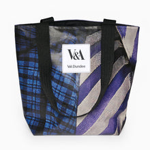 Load image into Gallery viewer, Portrait tote bag made from recycled PVC exhibition banner with blue graphic artwork and white V&A Dundee logo.
