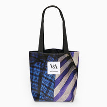 Load image into Gallery viewer, Upcycled portrait tote bag made from recycled Kimono exhibition banner in purple and blue with white V&A Dundee logo patch on the front.