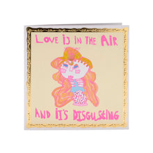 Load image into Gallery viewer, Love Is in the Air greetings card with illustration of girl with long hair and pink writing surrounded by a gold frame by Arthouse Unlimited