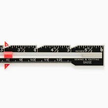 Load image into Gallery viewer, Close-up of Merchant & Mills metal sewing gauge showing measurement markings and slider