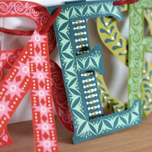 Load image into Gallery viewer, Close-up of patterned Merry Christmas paper letters by Cambridge Imprint