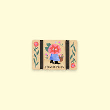 Load image into Gallery viewer, Flower press with cute illustrated character surrounded by flowers on a beige background