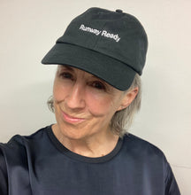 Load image into Gallery viewer, Person wearing a black Runway Ready embroidered cap from V&A Dundee’s Catwalk collection.
