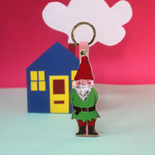 Load image into Gallery viewer, Welcome Gnome leather key ring displayed beside a colourful illustrated house scene by Ark Colour Design