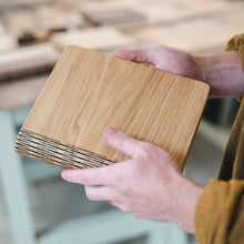 Load image into Gallery viewer, Person holding a wooden cutting board with a blurred background