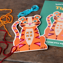 Load image into Gallery viewer, Wooden tiger stitch board being threaded with colourful yarn