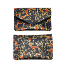 Load image into Gallery viewer, Three leather popper purses with foil embossed designs, in beige, pink, and black color, displayed against a white background.