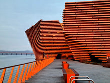 Load image into Gallery viewer, Marmalade Sunrise photograph of V&A Dundee on the waterfront by Neil McFarlane