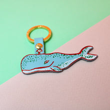 Load image into Gallery viewer, A leather keyring designed in the shape of whale, in light blue with metallic foil details.
