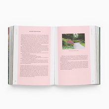 Load image into Gallery viewer, Open book with pink pages and a photograph of a garden on a white background

