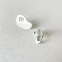 Load image into Gallery viewer, Pair of abstract silver earrings on a light gray background
