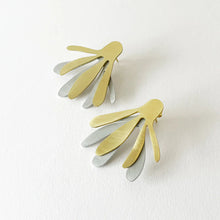 Load image into Gallery viewer, Gold and silver leaf-shaped statement earrings on a white background
