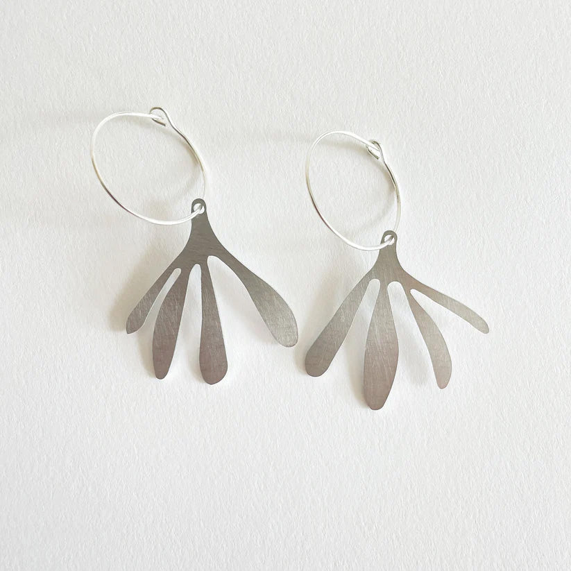 A pair of abstract brushed aluminium drop earrings with sterling silver hoops, displayed against a white background.