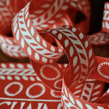 Load image into Gallery viewer, Close up detail of red and white patterened Cambridge Imprint paperchains
