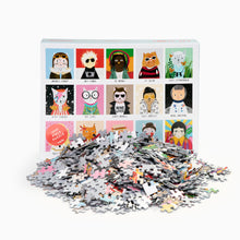 Load image into Gallery viewer, Jigsaw puzzle box with illustrated colourful cat characters and a pile of puzzle pieces on a white background

