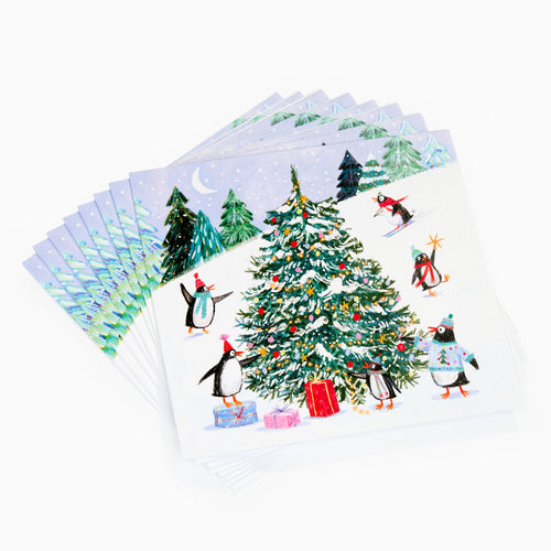 Set of Christmas-themed cards with penguins and a decorated tree on a white background