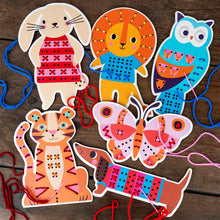 Load image into Gallery viewer, Colorful animal-themed paper crafts on a wooden surface with yarn.
