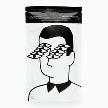 Load image into Gallery viewer, Packaging of drinking chocolate with a stylized illustration of a person wearing multiple pairs of glasses.
