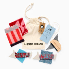 Load image into Gallery viewer, Donna Wilson clothing repair kit with fabric samples and drawstring bag on a white background
