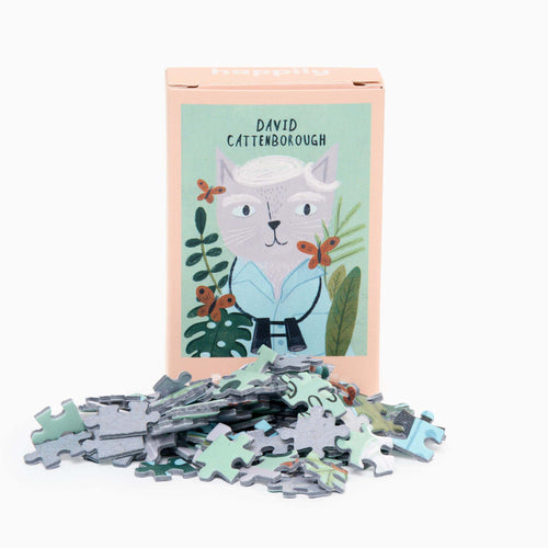 A puzzle box with the image of David Cattenborough on the cover, accompanied by a pile of puzzle pieces spread out in front.