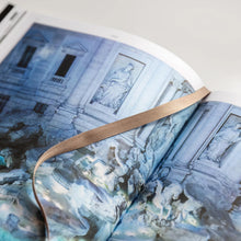 Load image into Gallery viewer, Open book from Catwalk The Art of The Fashion Show A-Z exhibition catalogue book with close up detail of the Fendi Trevi Fountain fashion show and a ribbon marker.
