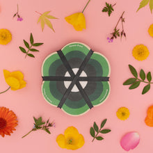 Load image into Gallery viewer, Flower press on a pink background with flowers and leaves
