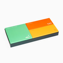 Load image into Gallery viewer, Colorful eyeglass packaging box with green, orange, and yellow sections on a white background.
