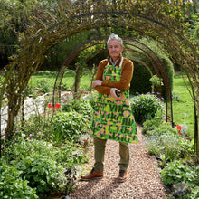 Load image into Gallery viewer, modern gardening apron on a man with abstract pattern in green and pink 
