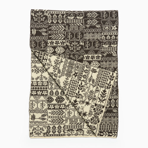 Patterned pure wool scarf with black and white design on a white background