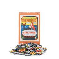 Mermaid sardine can-shaped puzzle with colorful pieces on a white background