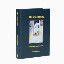Load image into Gallery viewer, Hardcover book titled 'On the Street' by Edwin Heathcote with a black cover featuring a photograph of a city street scene.
