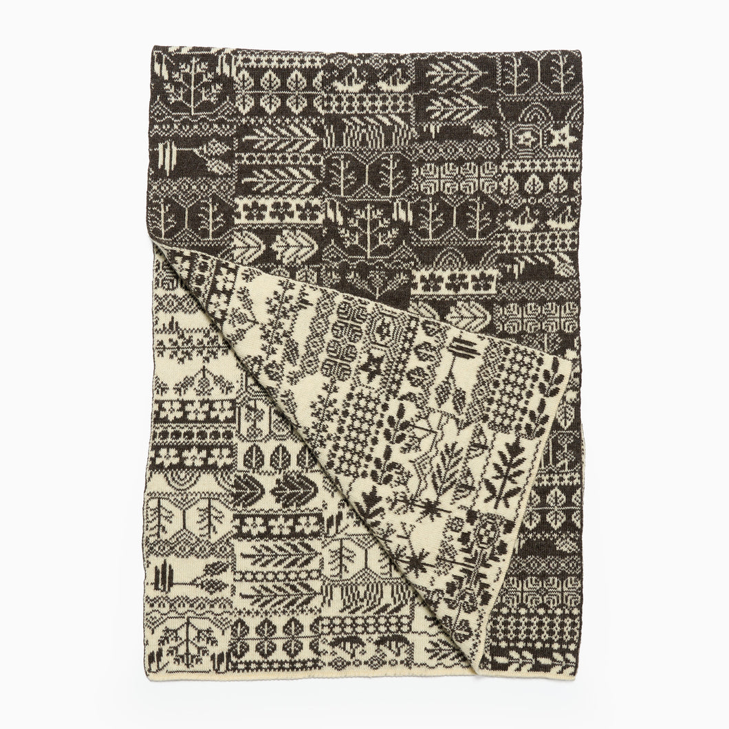 Patterned pure wool scarf with black and white design on a white background