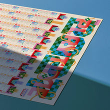Load image into Gallery viewer, Angled view of the Risotto 2027 A1 wall planner with fluorescent graphic design
