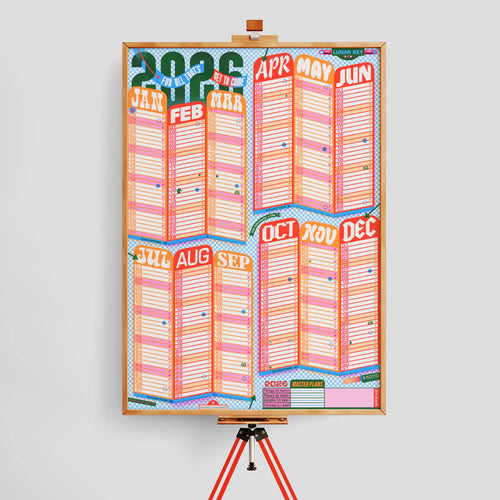 Colorful calendar poster on an easel against a light gray background