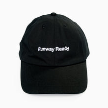 Load image into Gallery viewer, Black organic cotton baseball cap embroidered with “Runway Ready” in white, created for V&amp;A Dundee’s Catwalk fashion exhibition.
