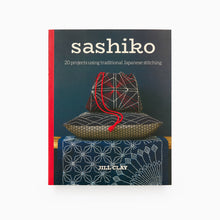 Load image into Gallery viewer, The cover of the book titled &#39;sashiko: 20 projects using traditional Japanese stitching&#39; by Jill Clay, featuring a photograph of a traditional Japanese basket with Sashiko stitching on it.
