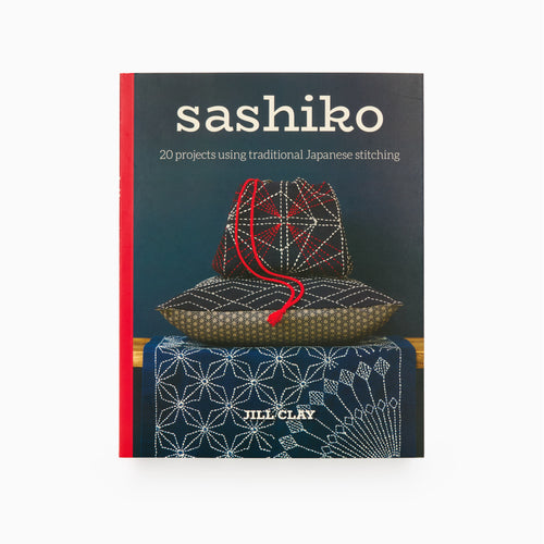 The cover of the book titled 'sashiko: 20 projects using traditional Japanese stitching' by Jill Clay, featuring a photograph of a traditional Japanese basket with Sashiko stitching on it.