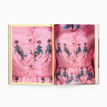Load image into Gallery viewer, Open book showing pink fabric with embroidered patterns on a white background
