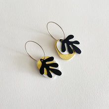 Load image into Gallery viewer, A pair of Tideline earrings with matte anodised aluminium, brushed aluminium, brass, and sterling silver components, presented on a white background.
